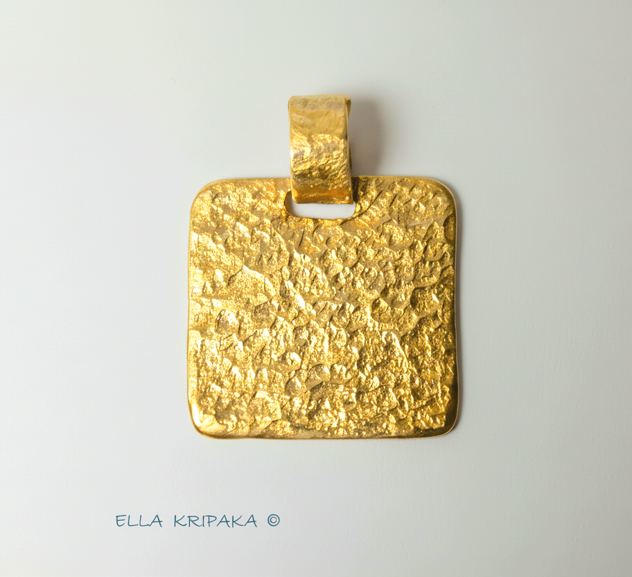 Hammered 24k gold, pure 9999 gold square pendant with shiny forged gold textures on white paper surface, artist-jeweler 'Ella Kripaka' branding