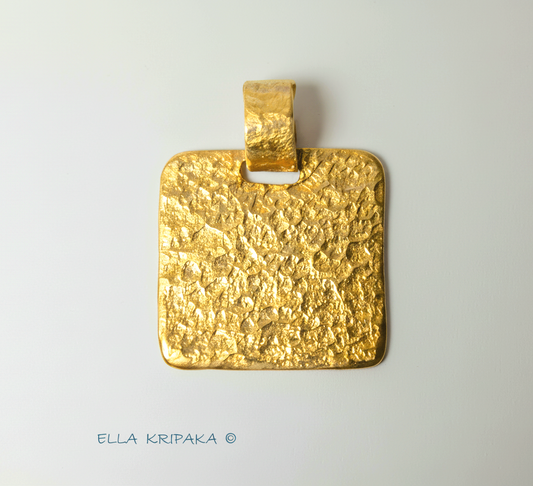 Hammered 24k gold, pure 9999 gold square pendant with shiny forged gold textures on white paper surface, artist-jeweler 'Ella Kripaka' branding