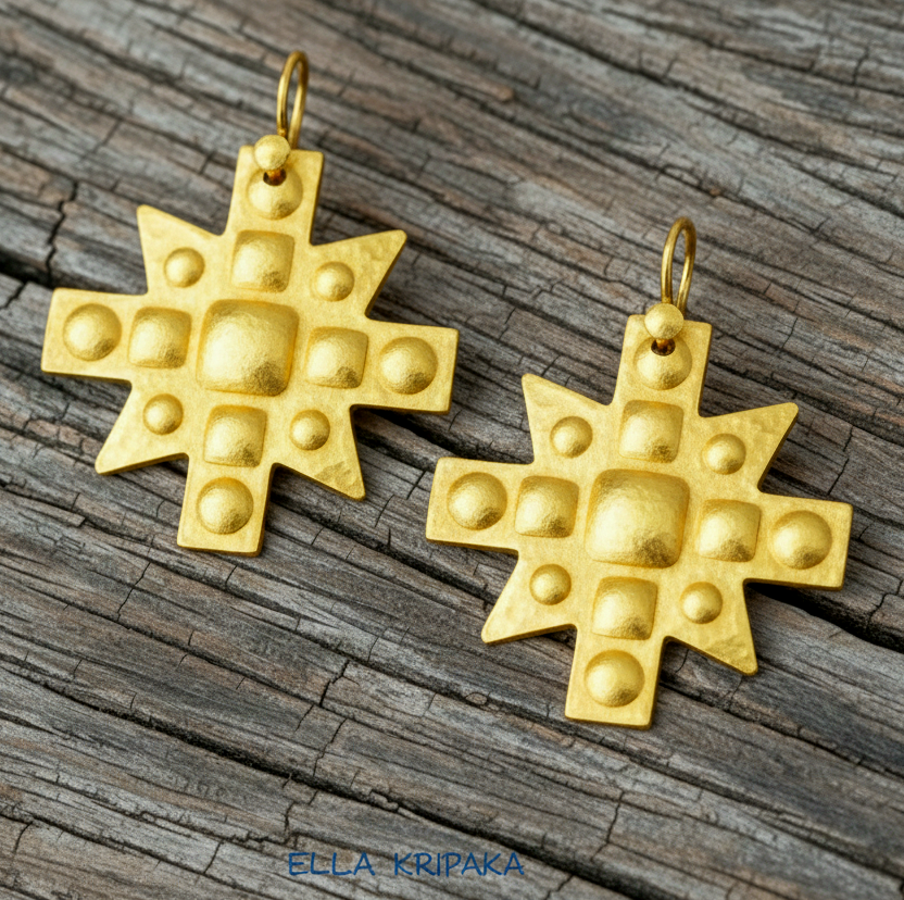 Hammered 24k 9999 Gold Byzantine cross earrings on a old wooden background with 'Ella Kripaka' branding