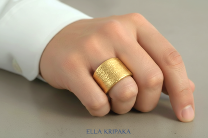 Hammered 24k Gold 9999 gold thick ring signet with textured gold worn on model's finger and on a grey neutral background, branded 'Ella Kripaka'
