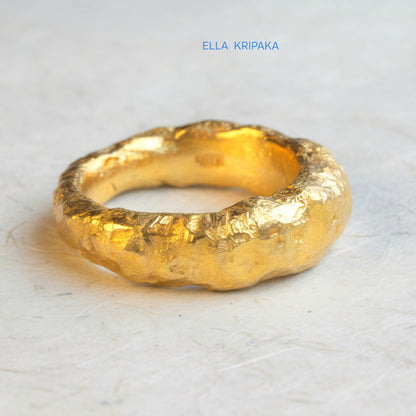 Hammered organic 24k Gold 9999 gold uneven signet thick ring with textured gold on a white craft paper background, branded 'Ella Kripaka'