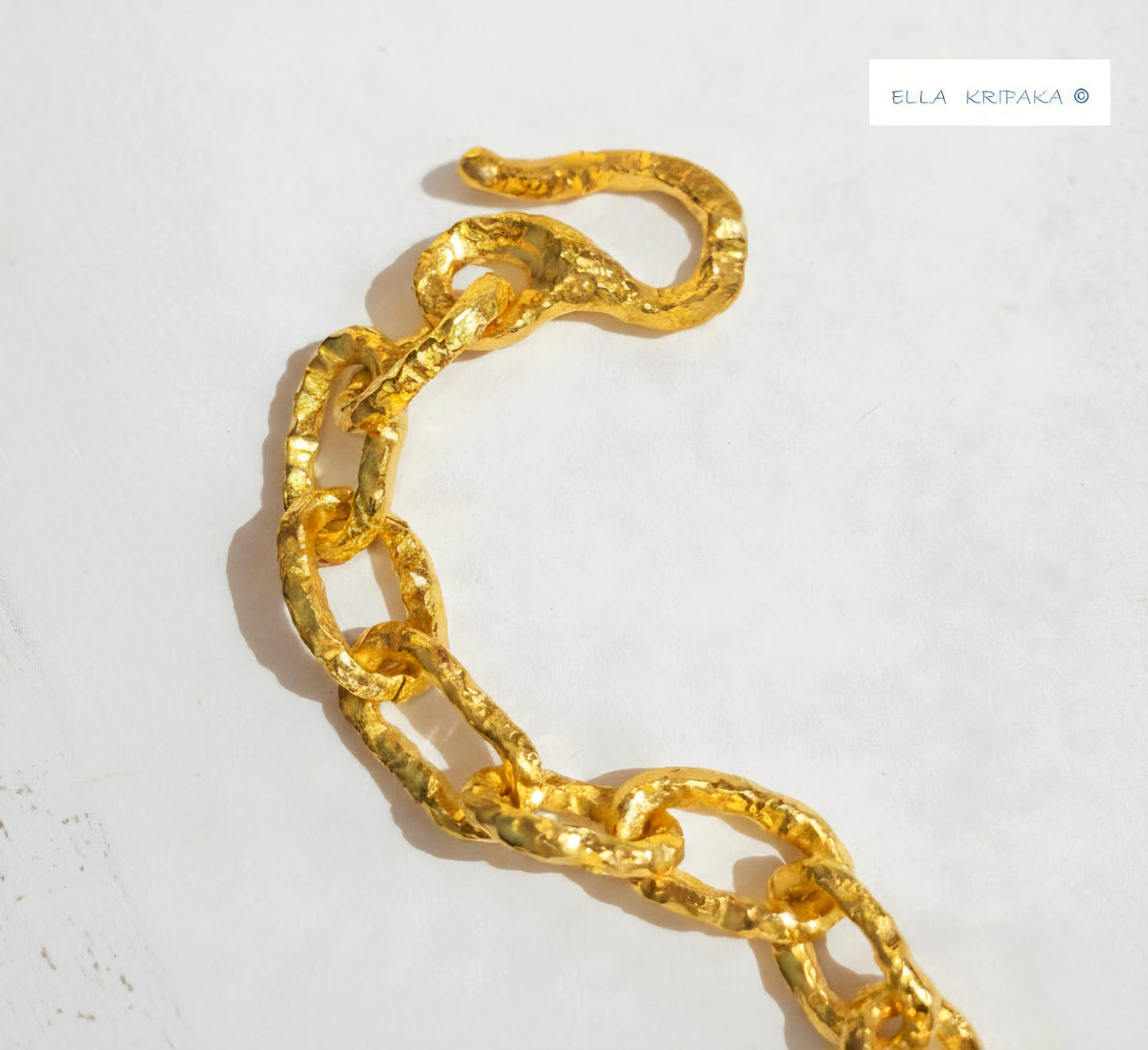 Hammered 24k 9999 gold organic chain with hammered uneven textures and a thick hook clasp, artist name 'Ella Kripaka'
