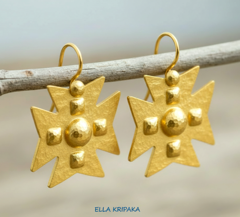 Hammered 24k 9999 Gold Byzantine cross earrings on a old wooden background with 'Ella Kripaka' branding