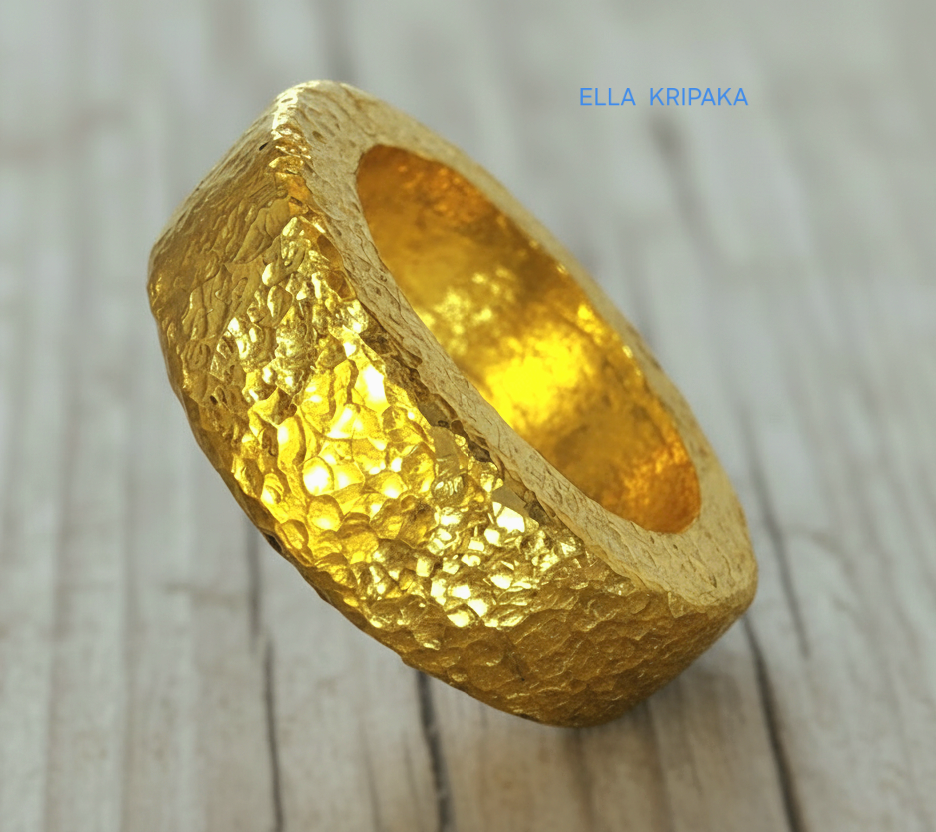Hammered 24k 9999 Gold thick ring Ancient Rome style with a textured forged gold surface on a old wooden background, branded 'Ella Kripaka'