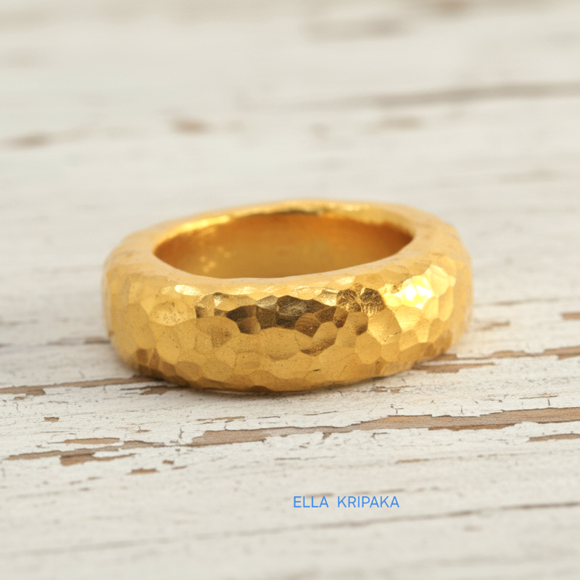 Hammered 24k Gold 9999 gold Ancient Rome  thick ring band with textured gold on a white rustic wooden background, branded 'Ella Kripaka'
