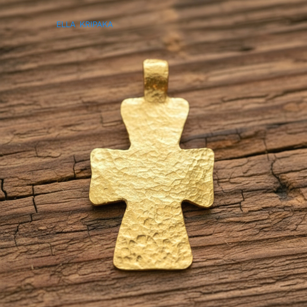 Hammered 24k gold textured cross pendant on rustic old wooden surface, creator artist-jeweler 'Ella Kripaka' branding