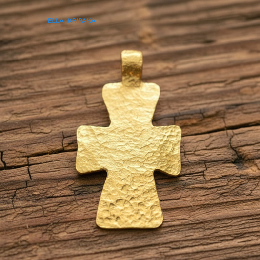 Hammered 24k gold textured cross pendant on rustic old wooden surface, creator artist-jeweler 'Ella Kripaka' branding