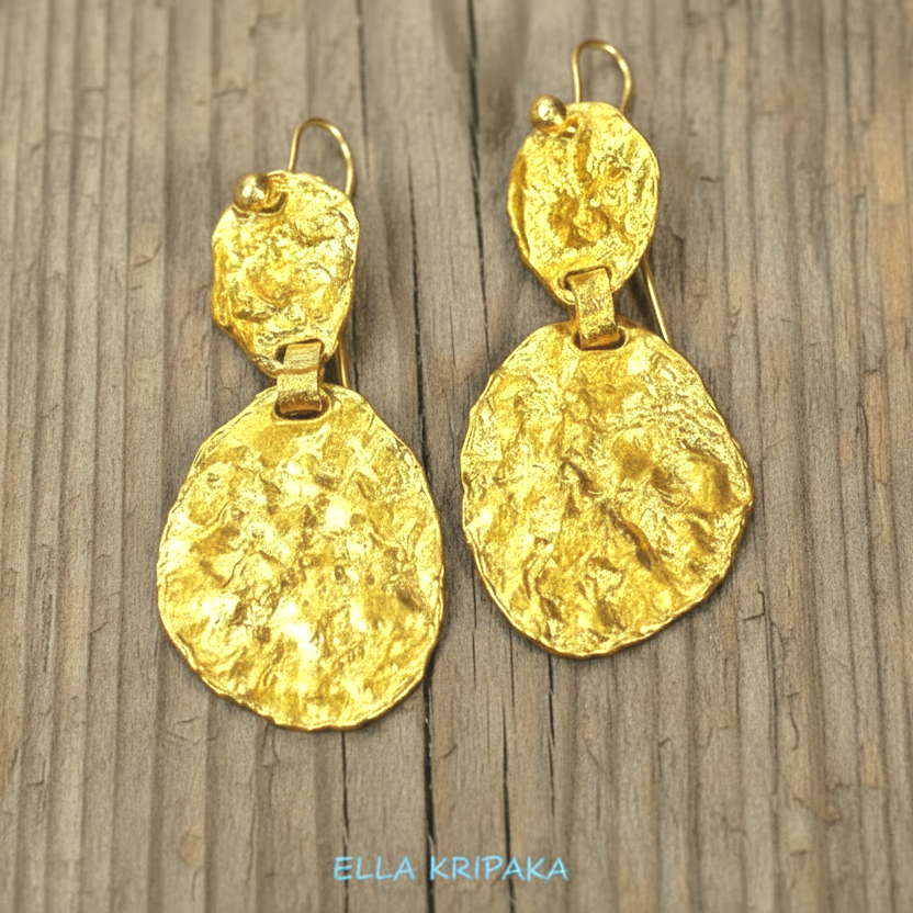 Organic 24k 9999 gold hammered wavy uneven earrings shiny gold textures are on old wooden background, artist-jeweler's name 'Ella Kripaka'
