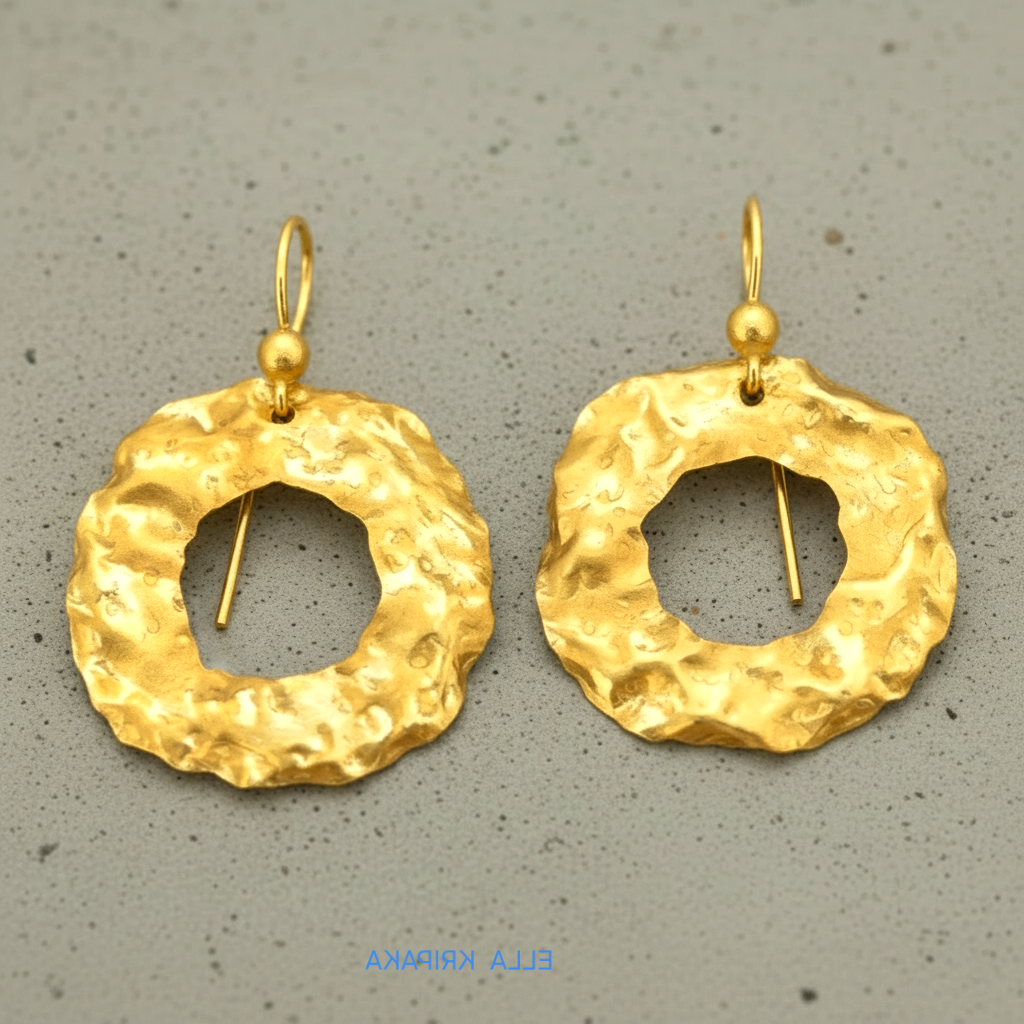 Organic 24k 9999 gold hammered wavy hoops earrings with shiny gold textures on grey background, artist-jeweler's name 'Ella Kripaka'
