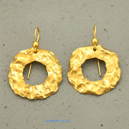 Organic 24k 9999 gold hammered wavy hoops earrings with shiny gold textures on grey background, artist-jeweler's name 'Ella Kripaka'