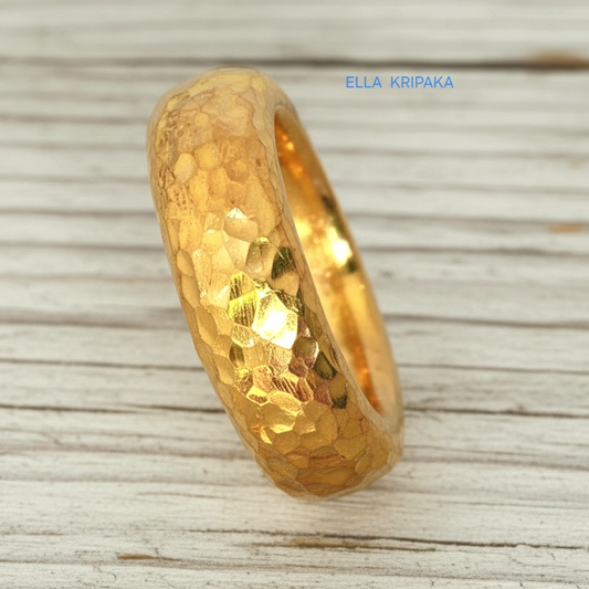 Hammered 24k Gold 9999 gold Ancient Rome  thick ring band with textured gold on a white rustic wooden background, branded 'Ella Kripaka'