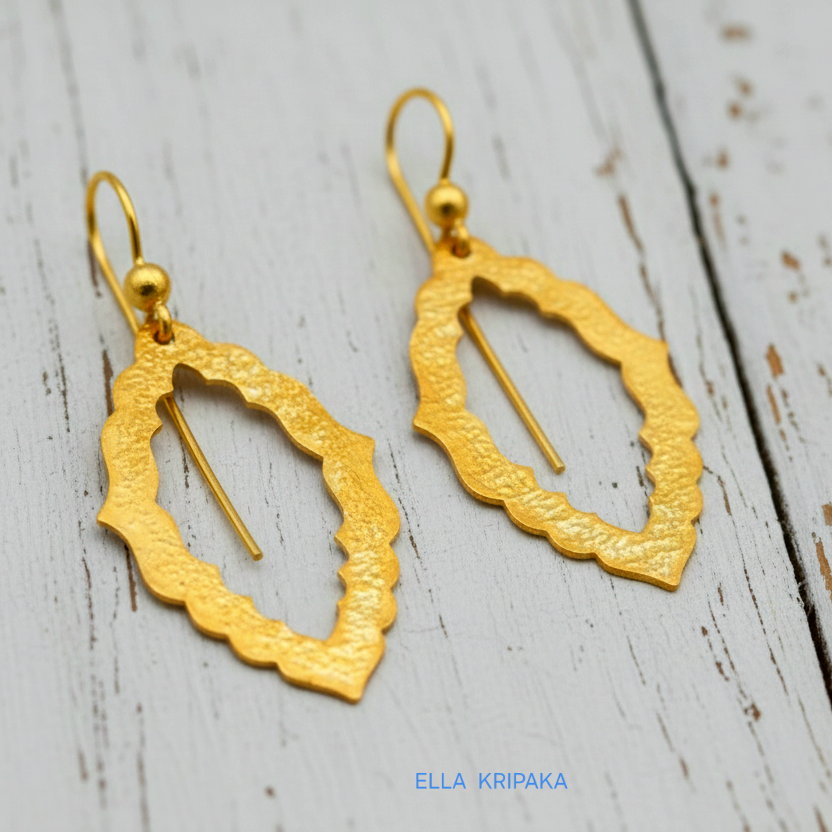 24k 9999 gold hammered Byzantine baroque convex earrings with shiny gold textures are on old white wooden background, artist-jeweler's name 'Ella Kripaka'