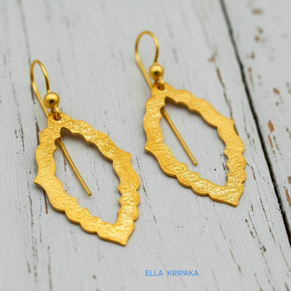 24k 9999 gold hammered Byzantine baroque convex earrings with shiny gold textures are on old white wooden background, artist-jeweler's name 'Ella Kripaka'
