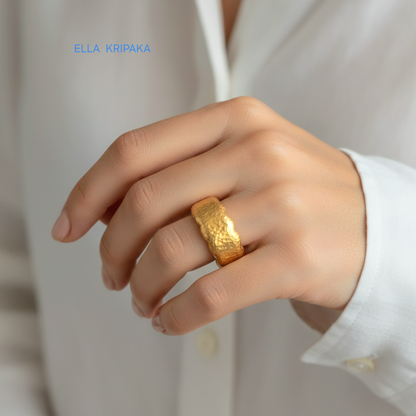 Organic hammered 24k gold 9999 Gold textured wavy thick ring on a woman's finger and a neutral background with 'ELLA KRIPAKA' branding
