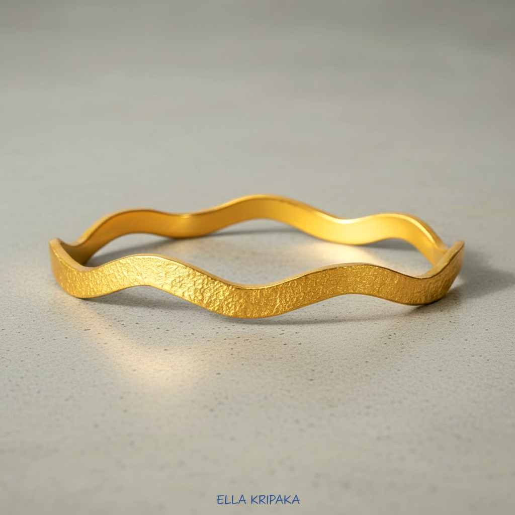 24k gold hammered bracelet textured bangle with wavy design on grey concrete background, branded 'Ella Kripaka'