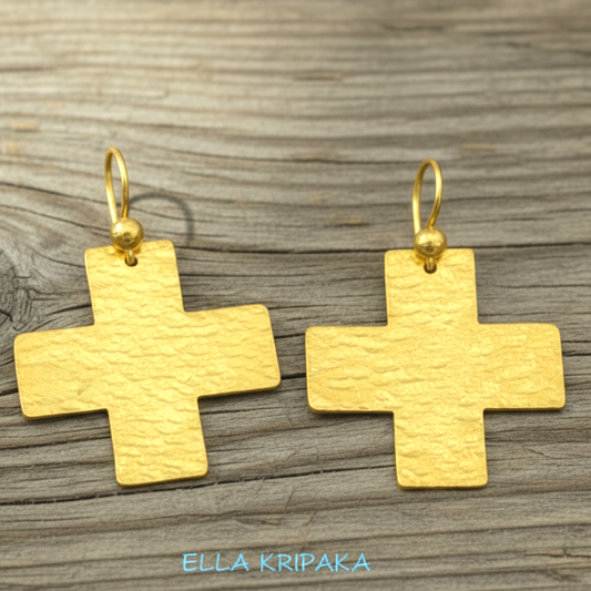 Hammered 24k 9999 Gold Byzantine cross earrings on a old wooden background with 'Ella Kripaka' branding
