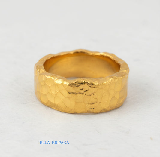 Organic hammered 24k 9999 Gold ring with uneven edges on white paper surface, artist-jeweler's name 'Ella Kripaka' is written in picture