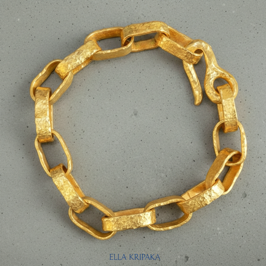 Hammered 24k 9999 gold chain thick bracelet with thick hook clasp Ancient Rome style on a grey background, artist-jeweler name 'Ella Kripaka' branding