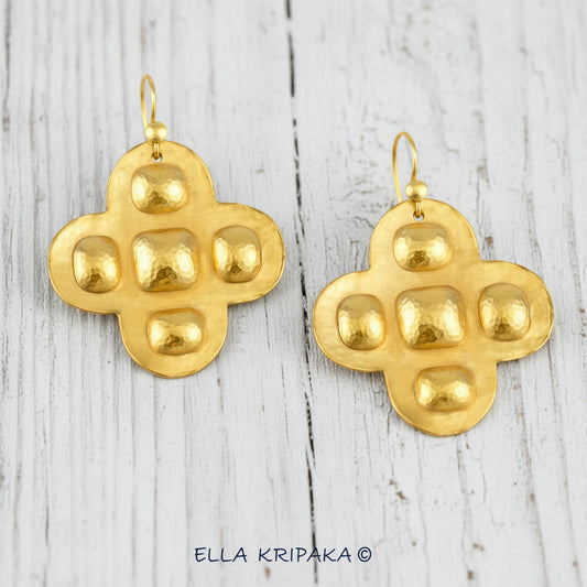 Hammered 24k Gold Byzantine cross earrings with convex squares and ovals on a white rustic wooden background, and with 'Ella Kripaka' branding