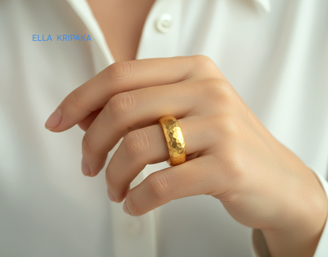Hammered 24k Gold 9999 gold Ancient Rome thick ring band with textured gold worn on model's finger and on a white background, branded 'Ella Kripaka'