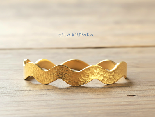 Wavy Hammered 24k 9999 Gold bangle bracelet on wooden surface, artist's name 'Ella Kripaka' branding