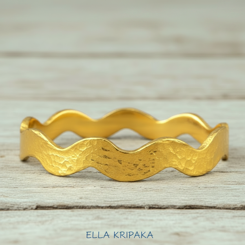 Wavy Hammered 24k 9999 Gold bangle bracelet on white wooden surface, artist's name 'Ella Kripaka' branding