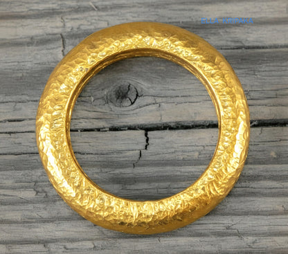 Hammered organic 24k Gold 9999 gold signet thick ring band with textured gold on a grey concrete background, branded 'Ella Kripaka'
