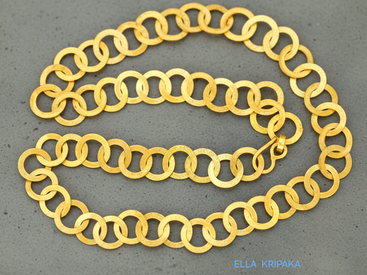 22k gold hammered chain necklace with thick hook clasp on a grey background, artist-jeweler's name 'Ella Kripaka' branding