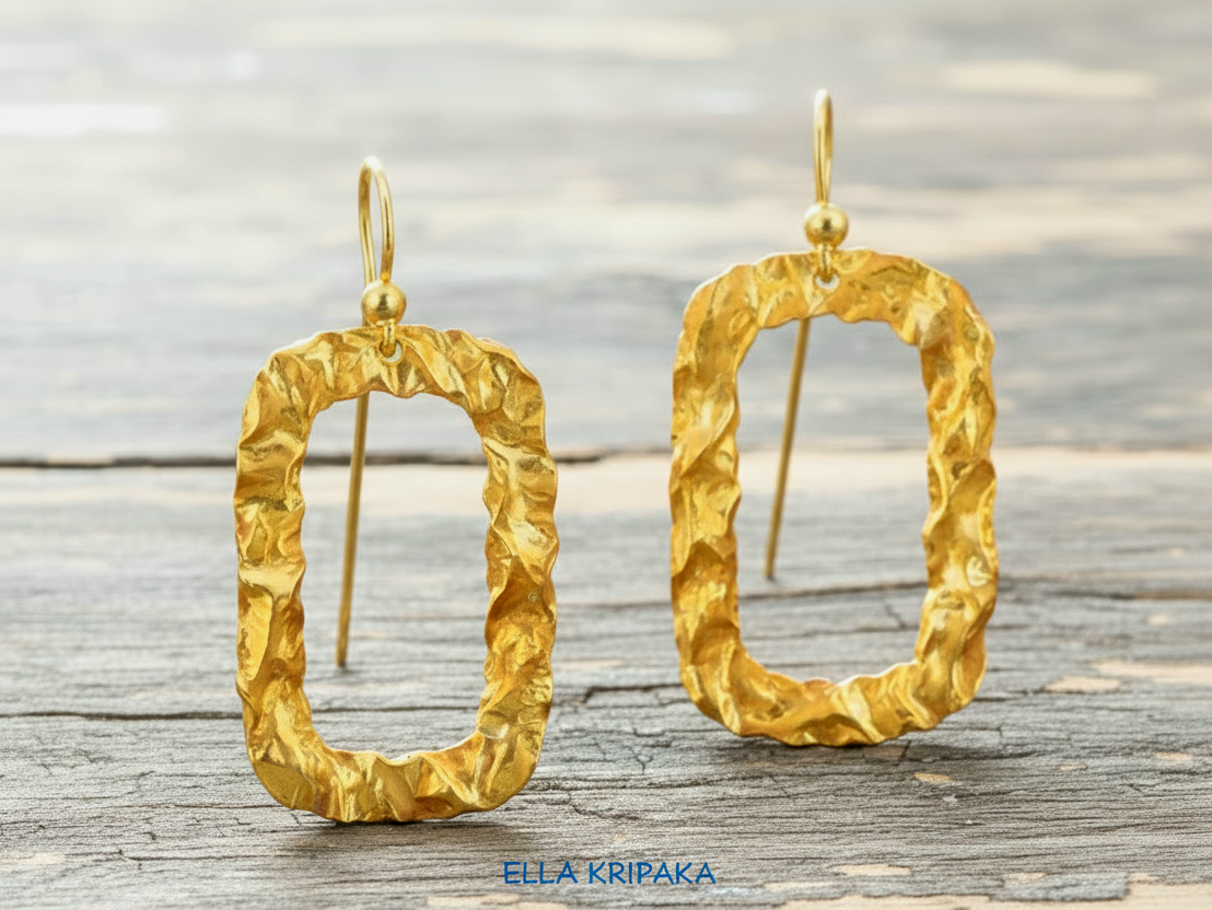 Organic hammered uneven 24k 9999 Gold hoops earrings on a grey old wooden surface, and with 'ELLA KRIPAKA' branding