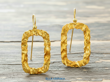 Organic hammered uneven 24k 9999 Gold hoops earrings on a grey old wooden surface, and with 'ELLA KRIPAKA' branding