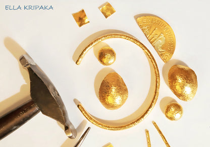 Hammered 24k 9999 gold cuff thick bracelet Ancient Rome style with parts of hammered gold jewelry and with jewelry hammer on a white background, artist-jeweler name 'Ella Kripaka' branding