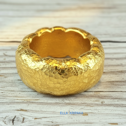 Organic hammered 24k gold 9999 Gold textured wavy thick ring on a wooden surface with 'ELLA KRIPAKA' branding