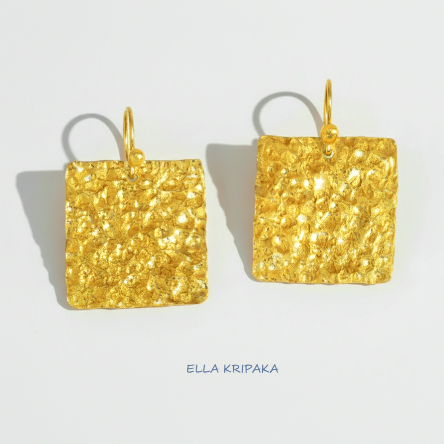 Organic 24k gold square earrings with textured reliefs on a white paper background with 'Ella Kripaka' branding
