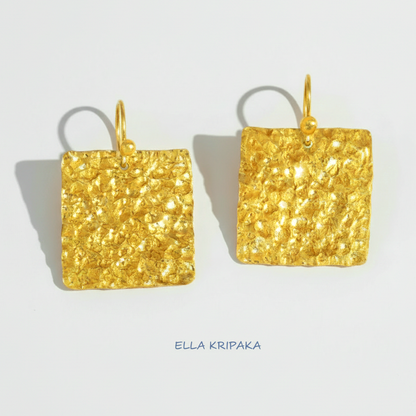 Organic 24k gold square earrings with textured reliefs on a white paper background with 'Ella Kripaka' branding