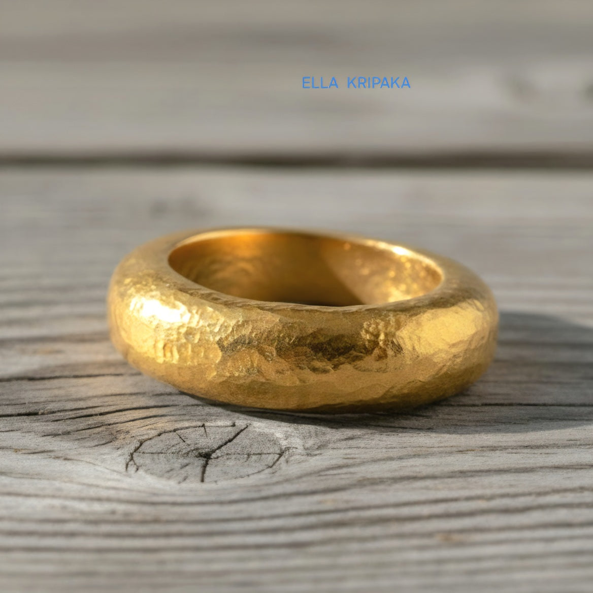 Hammered 24k Gold 9999 gold Ancient Rome  thick ring with textured forged gold on a grey old wooden background, branded artist-jeweler's name 'Ella Kripaka'