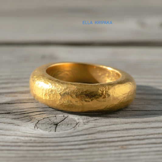 Hammered 24k Gold 9999 gold Ancient Rome  thick ring with textured forged gold on a grey old wooden background, branded artist-jeweler's name 'Ella Kripaka'