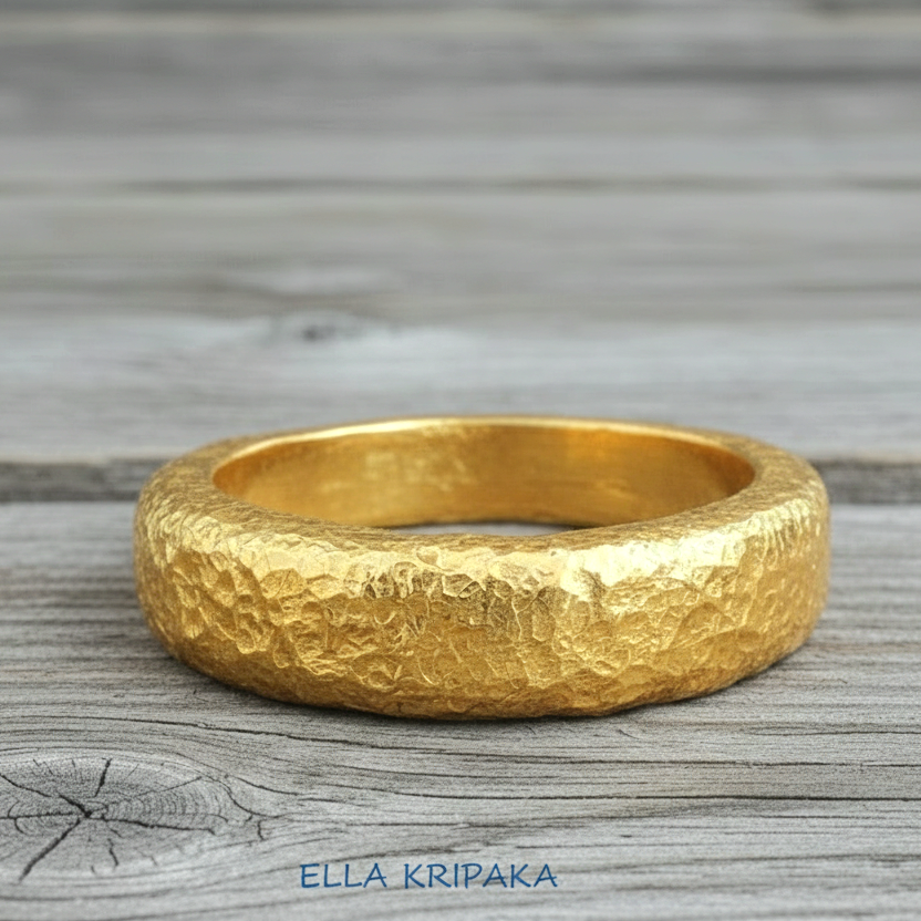 Hammered 24k Gold 9999 gold Ancient Rome  thick ring with textured forged gold on a grey old wooden background, branded 'Ella Kripaka'