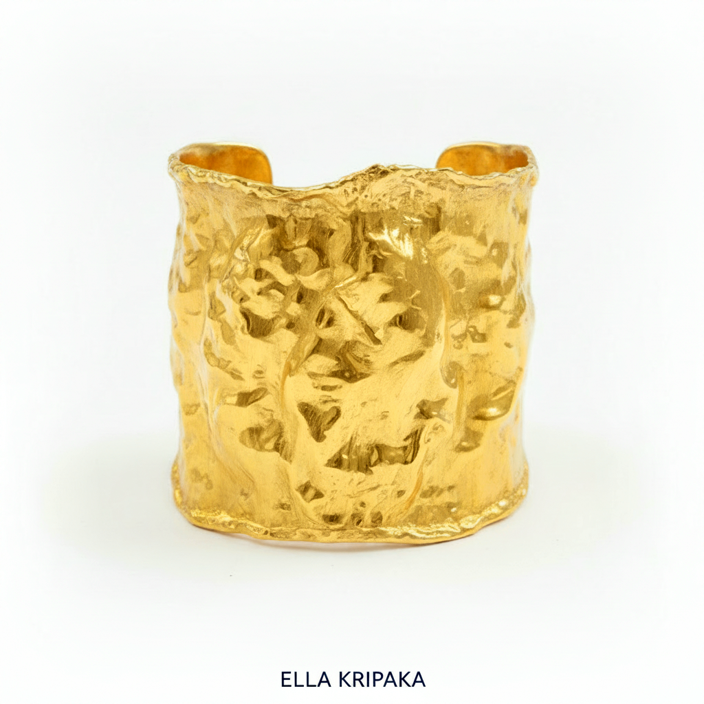Hammered 24k gold large cuff bracelet with convex uneven textures on a white background, and with artist 'Ella Kripaka' branding