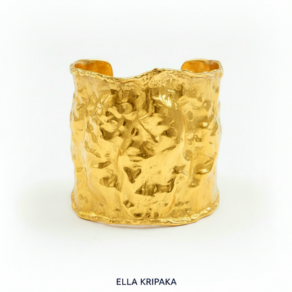Hammered 24k gold large cuff bracelet with convex uneven textures on a white background, and with artist 'Ella Kripaka' branding
