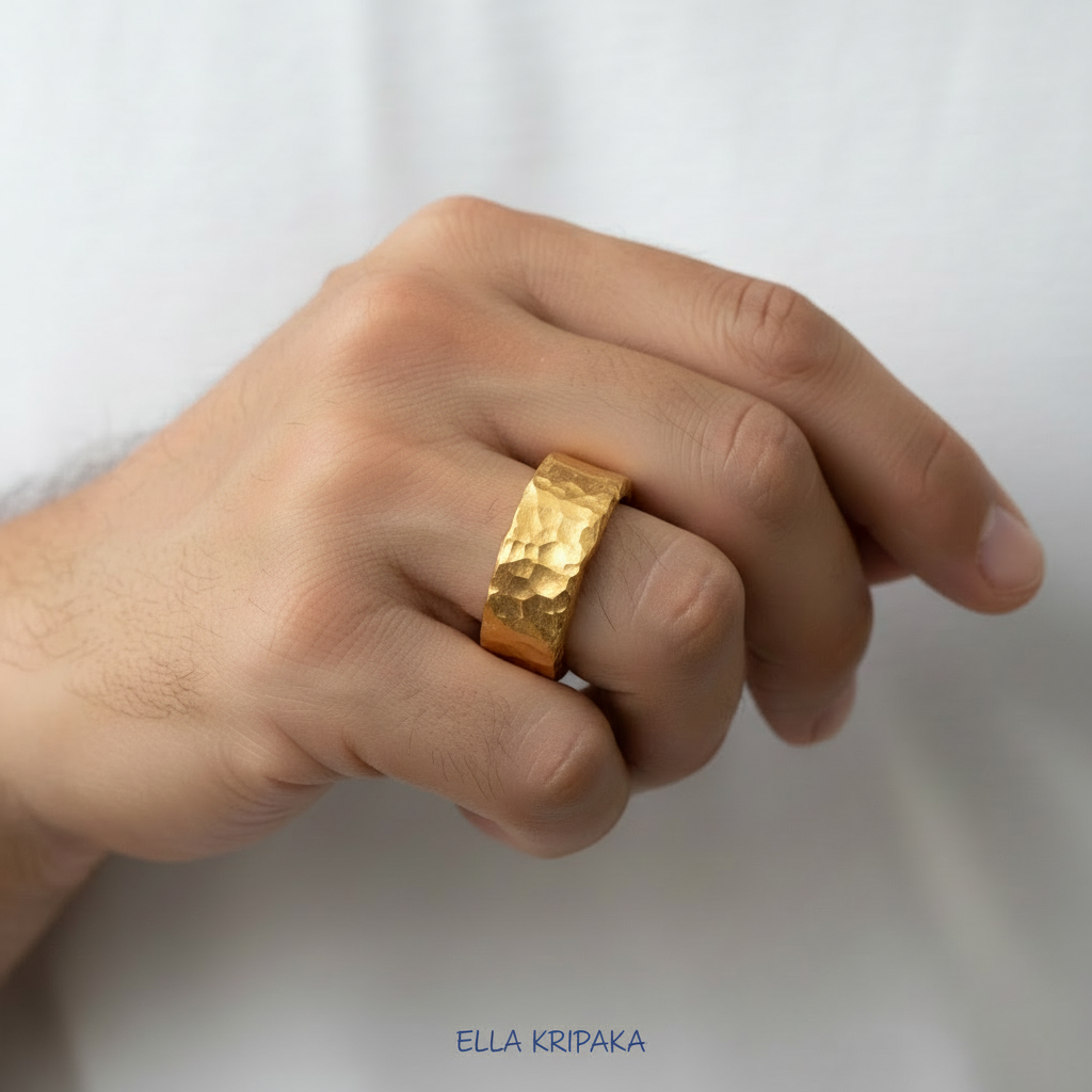 Organic hammered 24k 9999 Gold ring with uneven thick edges worn on person's finger and on a white background, artist-jeweler's name 'Ella Kripaka' is written in picture