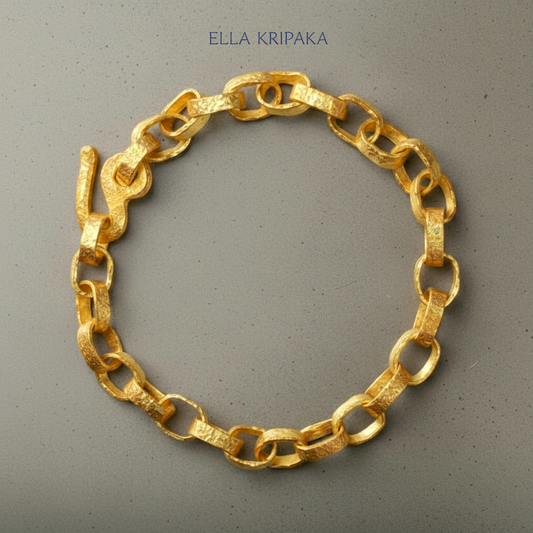 Hammered 24k 9999 gold chain thick bracelet with thick hook clasp Ancient Rome style on a grey background, artist-jeweler name 'Ella Kripaka' branding