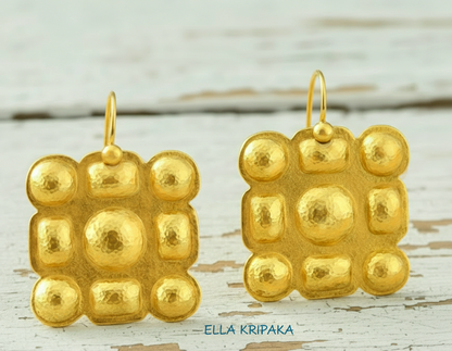 Hammered 24k gold Byzantine square earrings with shiny forged gold textures on old wooden surface, artist-jeweler 'Ella Kripaka' branding