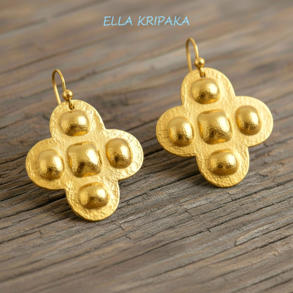 Hammered 24k 9999 Gold Byzantine cross earrings on a old wooden background with 'Ella Kripaka' branding