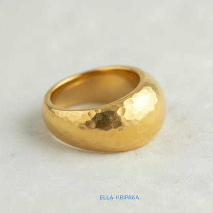 Hammered 24k 9999 Gold ring convex signet Ancient Rome style on white paper surface, artist-jeweler's name 'Ella Kripaka' branding