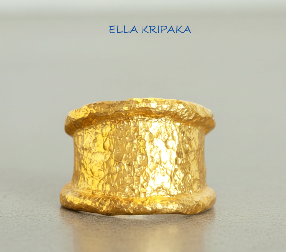 Organic hammered 24k 9999 gold ring signet with uneven thick edges on grey surface, artist-jeweler's name 'Ella Kripaka' is written in picture