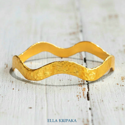 24k gold hammered bracelet textured bangle with wavy design on white rustic wooden background, branded 'Ella Kripaka'