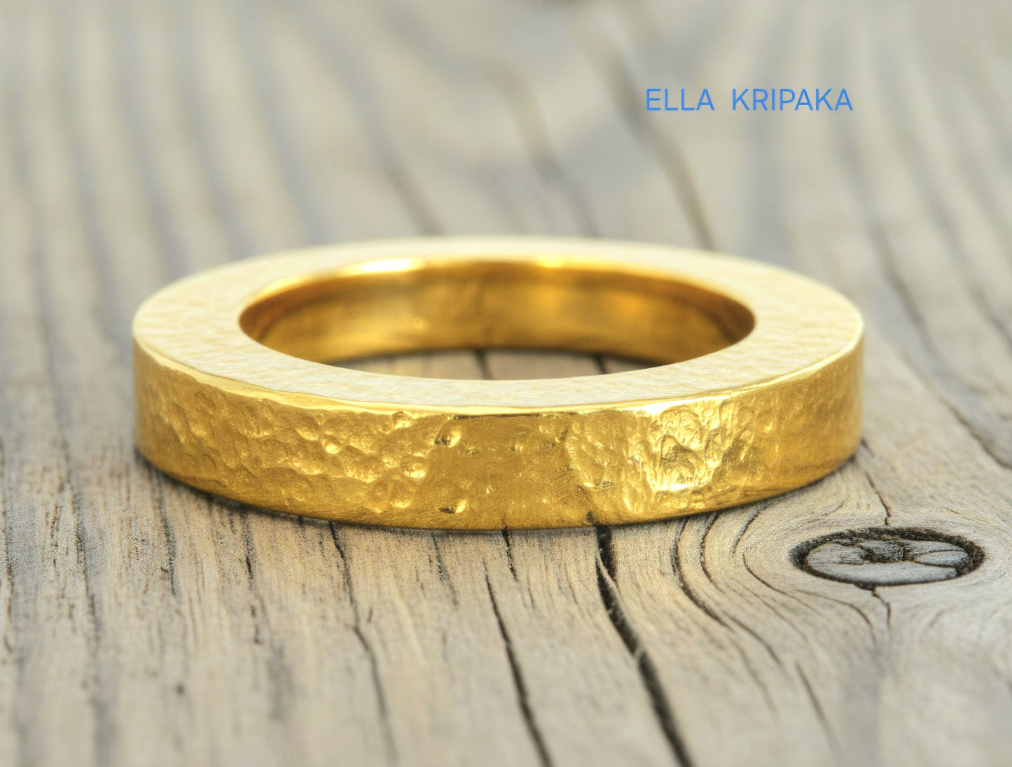 Hammered 24k Gold 9999 gold Ancient Rome  thick ring with textured forged gold on a grey old wooden background, branded artist-jeweler's name 'Ella Kripaka'