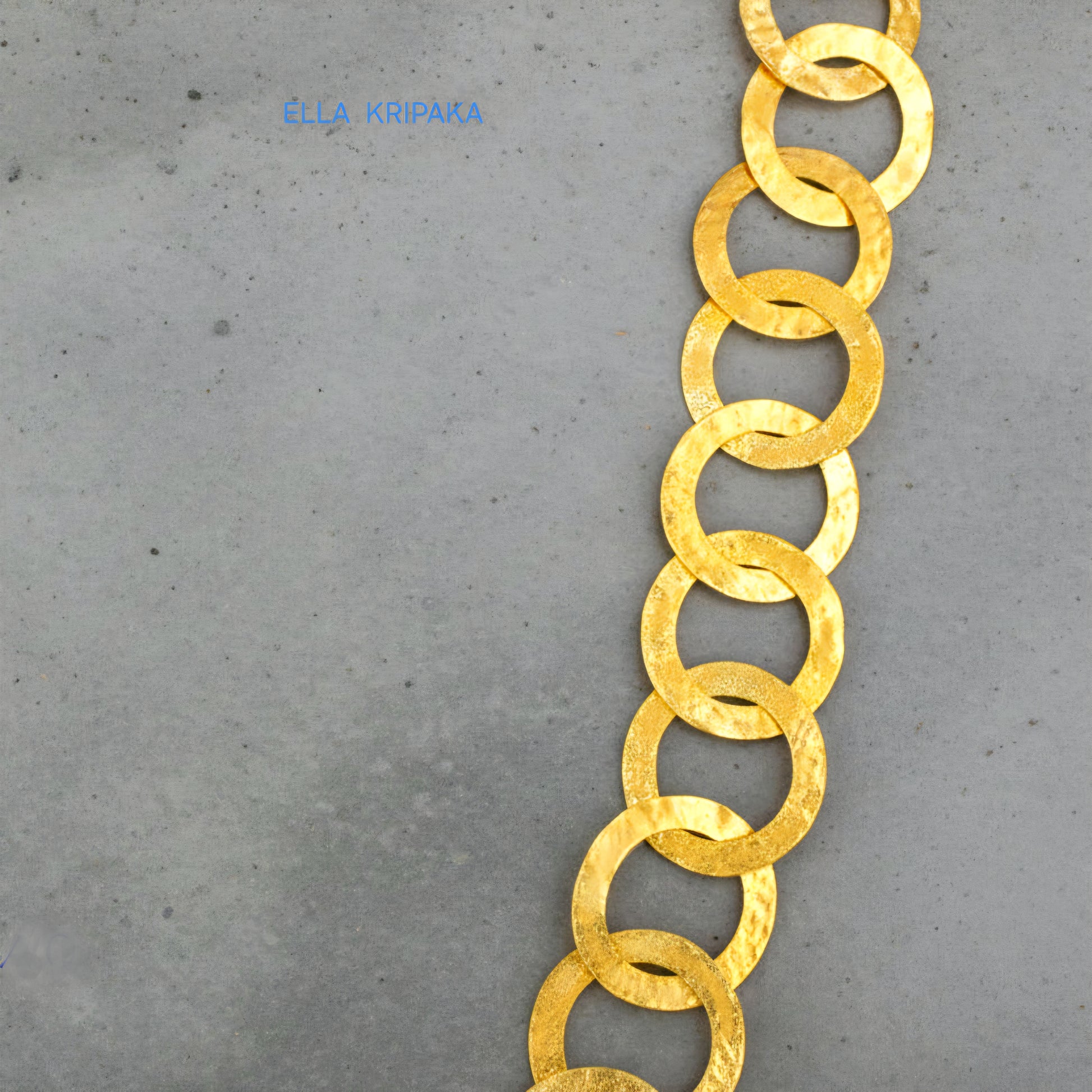 22k gold hammered chain necklace on a grey background, artist-jeweler's name 'Ella Kripaka' branding