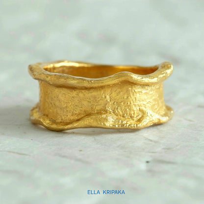 Organic 24k gold hammered ring with textured surface and uneven edges on a white craft  paper background, branded 'Ella Kripaka'