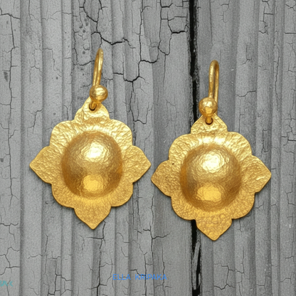 24k 9999 gold hammered Byzantine baroque convex earrings with shiny gold textures are on old wooden background, artist-jeweler's name 'Ella Kripaka'